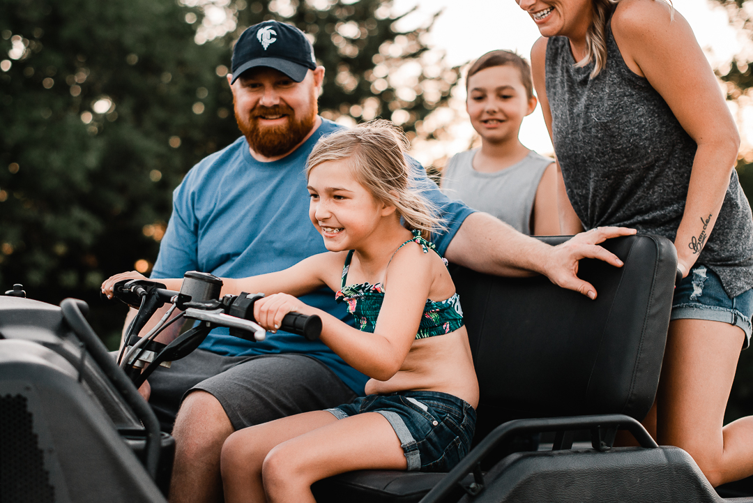 Family enjoying riding an argo during lifestyle photography session with Melissa Lindquist Photography.