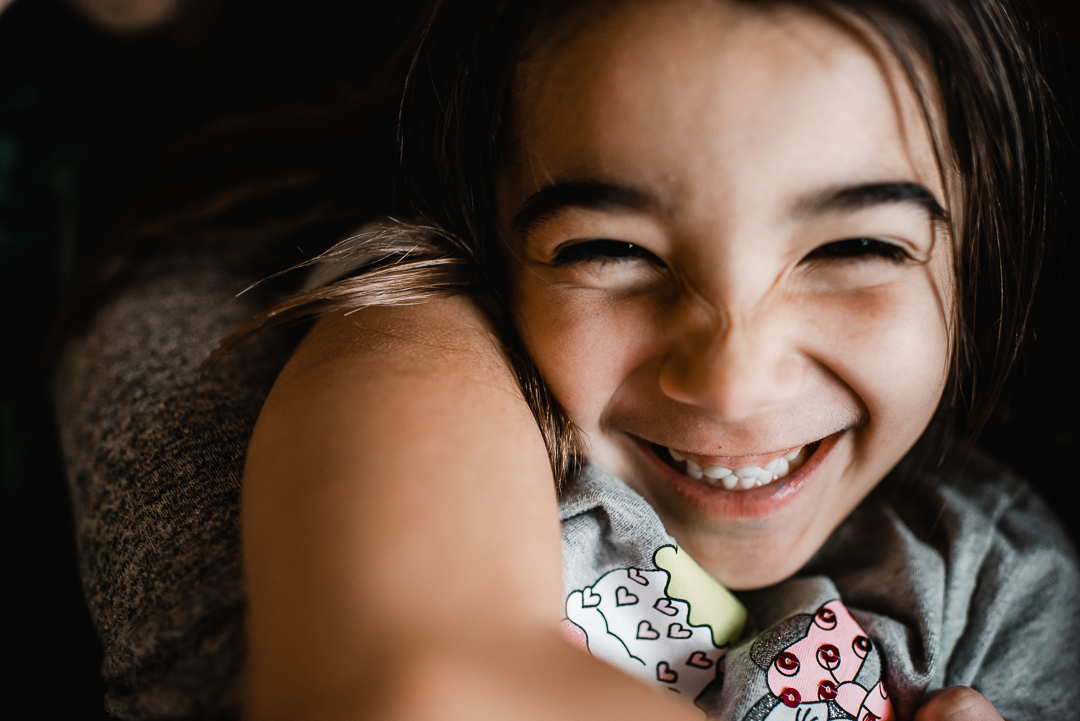 Little girl laughing during lifestyle photography session with Melissa Lindquist Photography.