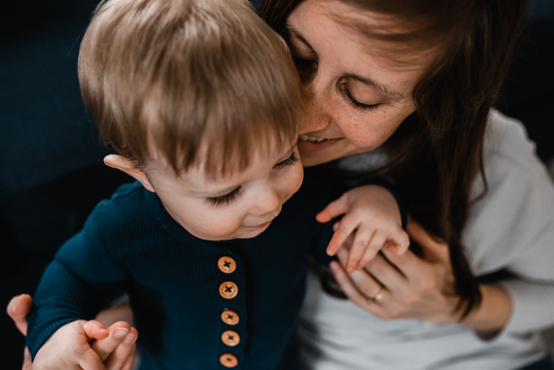 Mom and son cuddle during family photography session with Melissa Lindquist Photography in Omaha.