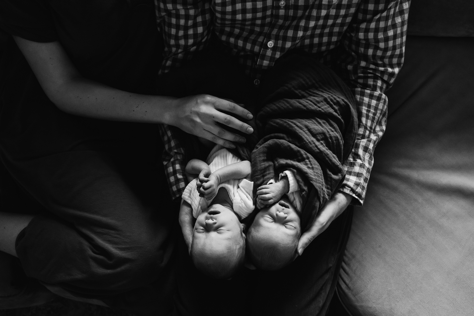 Omaha family cuddling with their newborn during their in-home newborn session with Melissa Lindquist Photography.