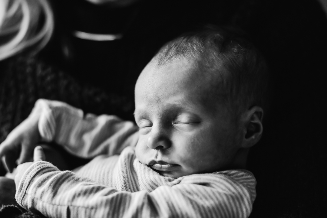 Newborn sleeping during in-home lifestyle photography session with Melissa Lindquist Photography in Omaha.