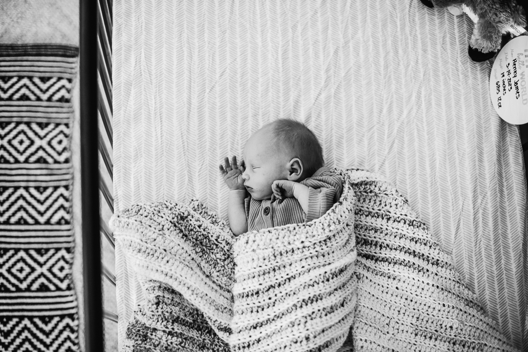 Newborn sleeping in his crib captured by Omaha Newborn Photographer Melissa Lindquist Photography.
