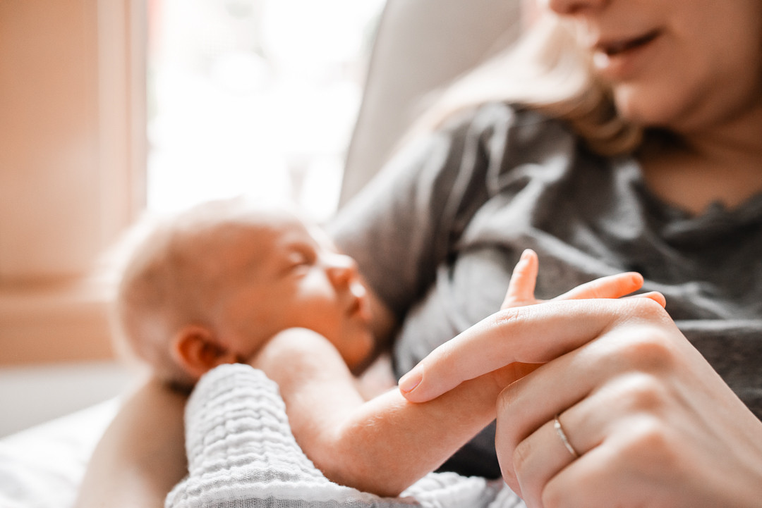 Newborn baby resting peacefully during an in-home newborn photography session in Omaha