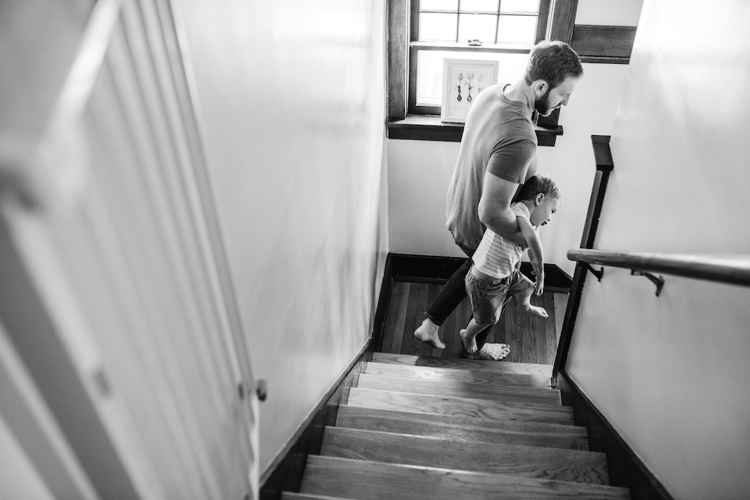 Candid family moments during an in-home family photography session in Omaha