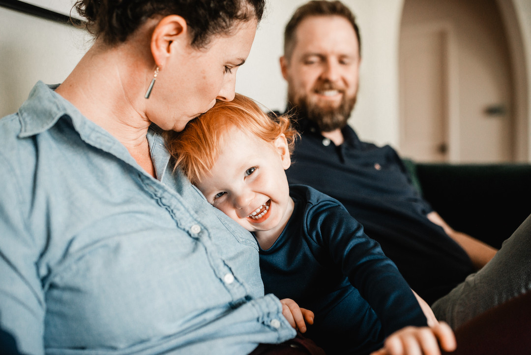 Candid family moments during an in-home family photography session in Omaha