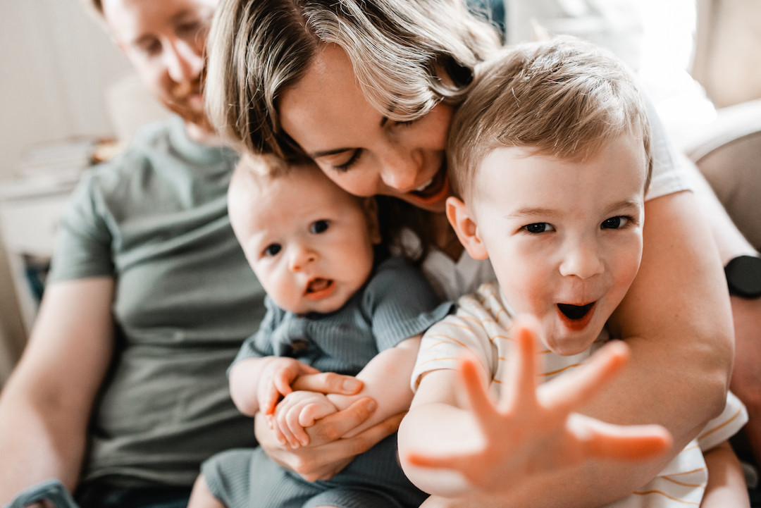 Candid family moments during an in-home family photography session in Omaha