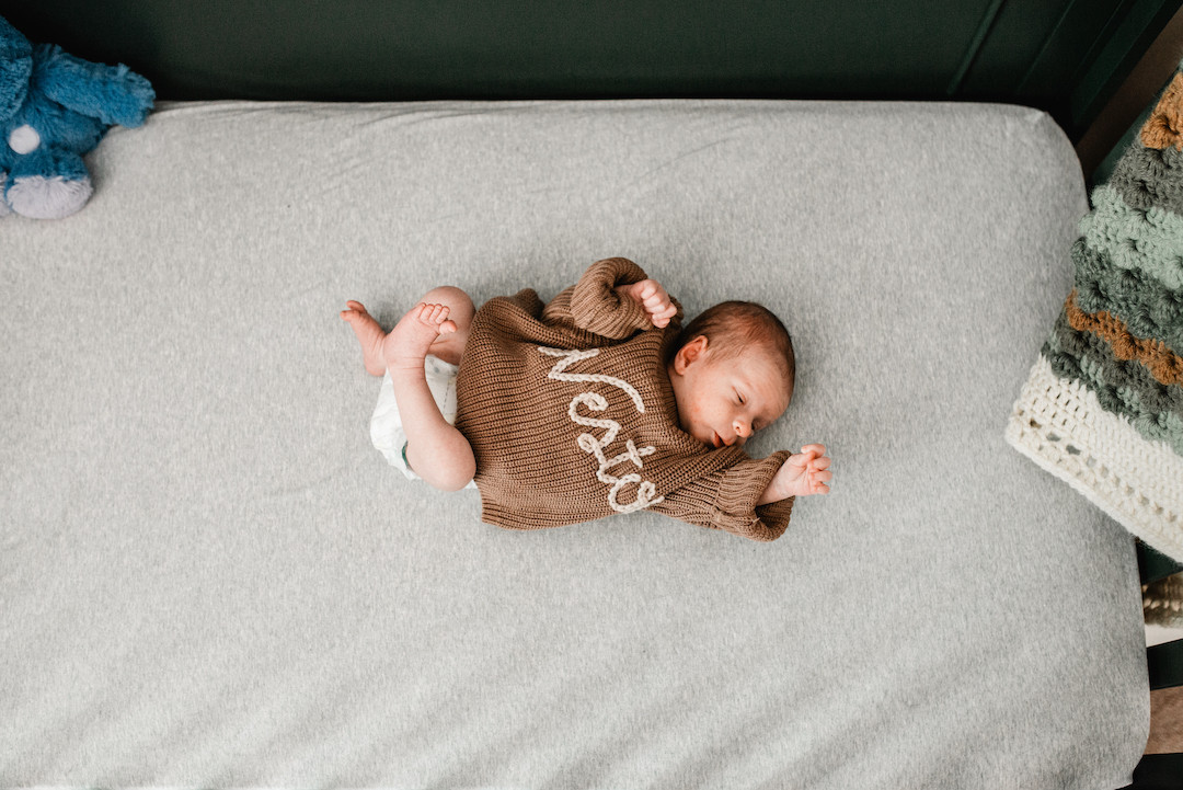 Newborn baby resting peacefully during an in-home newborn photography session in Omaha