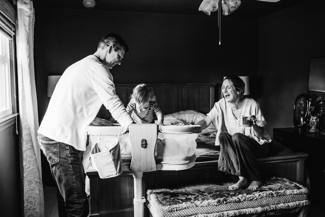 New parents bonding with their newborn during an in-home photography session in Omaha