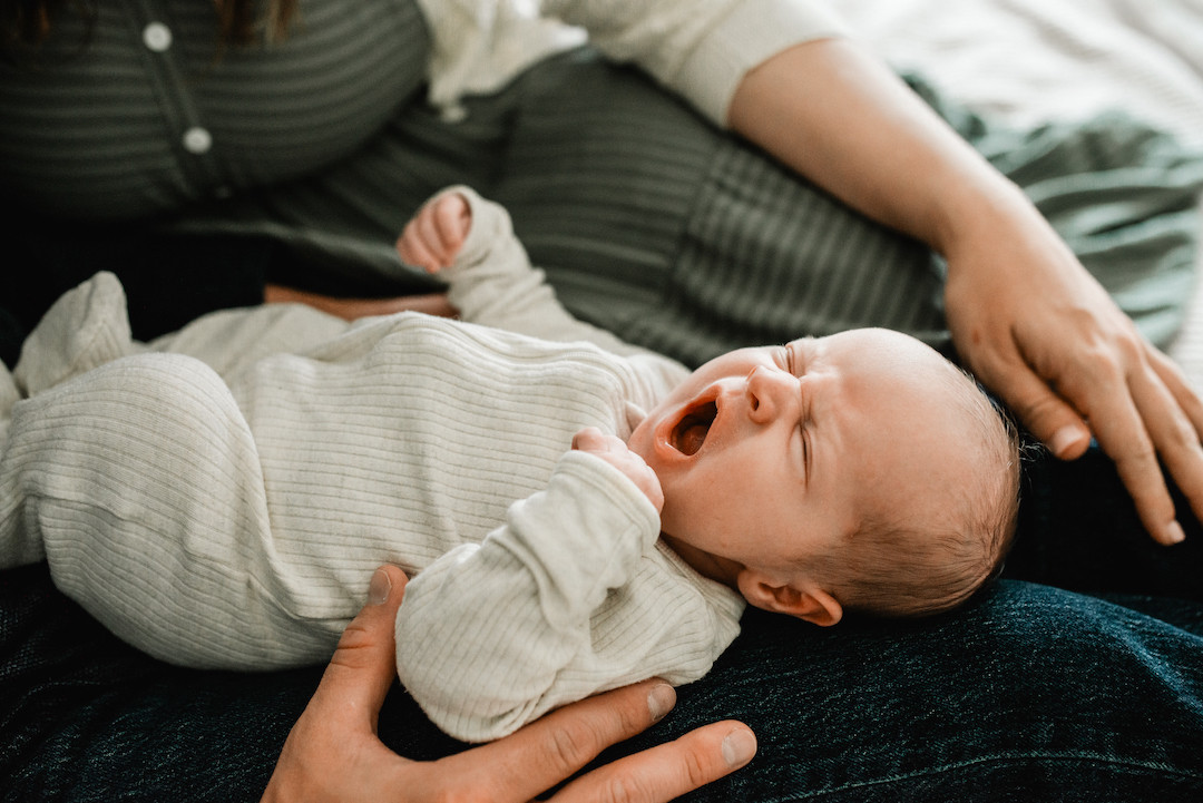 Newborn baby resting peacefully during an in-home newborn photography session in Omaha