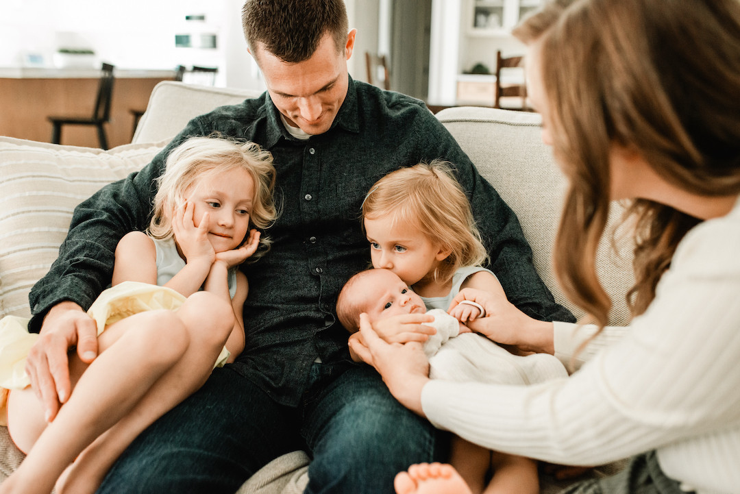 Newborn snuggled in a cozy home during an in-home newborn photography session in Omaha