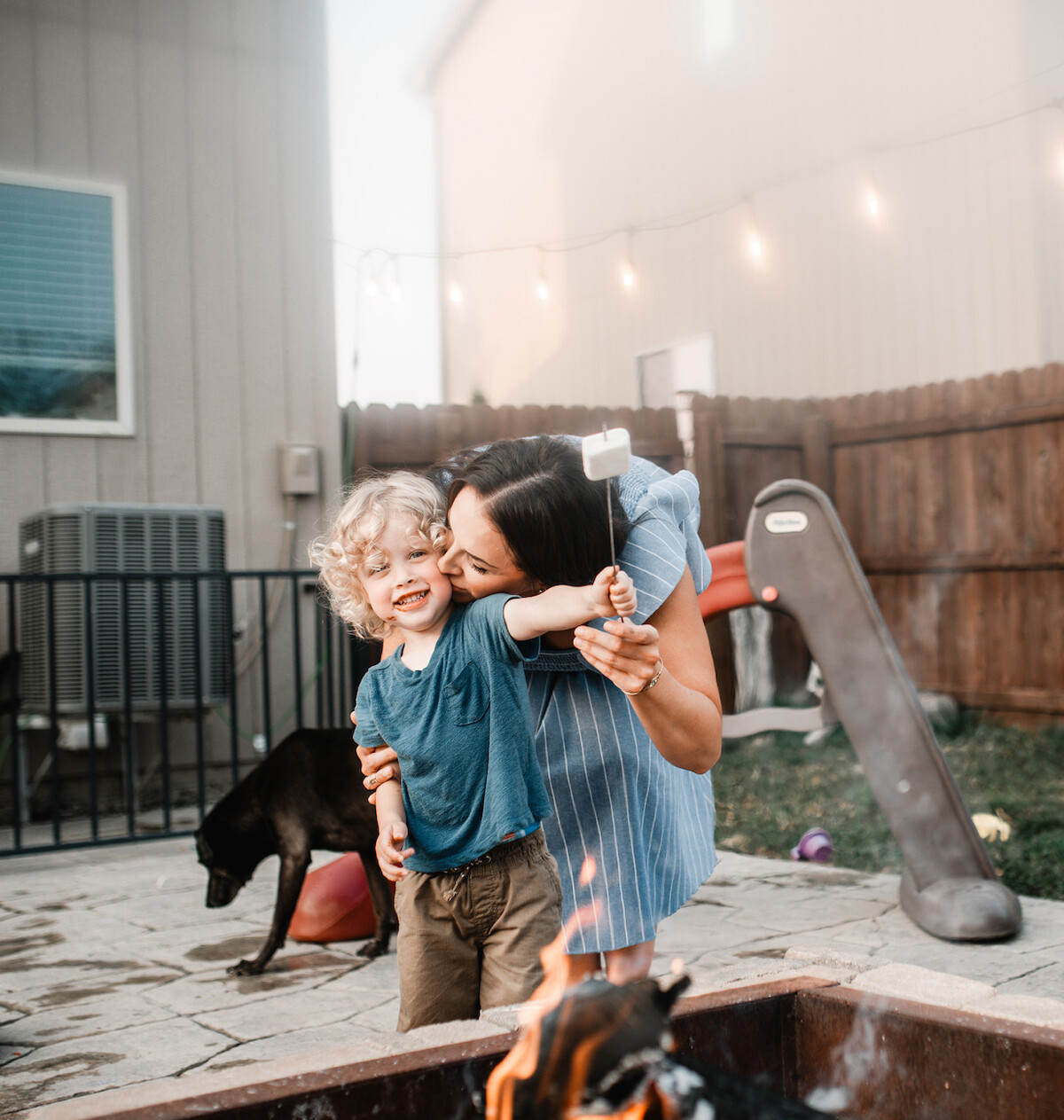 Mom kissing son during in-home photography session with Melissa Lindquist Photography.