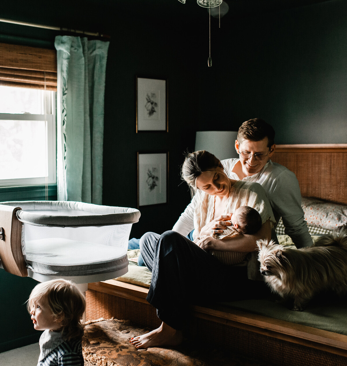 Mom and dad snuggling baby during in-home photography session with Melissa Lindquist Photography.